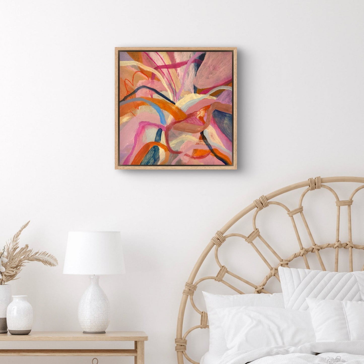 Hibiscus Dreaming Abstract Painting Print Framed 40x40cm hanging above a cane bed with white linen