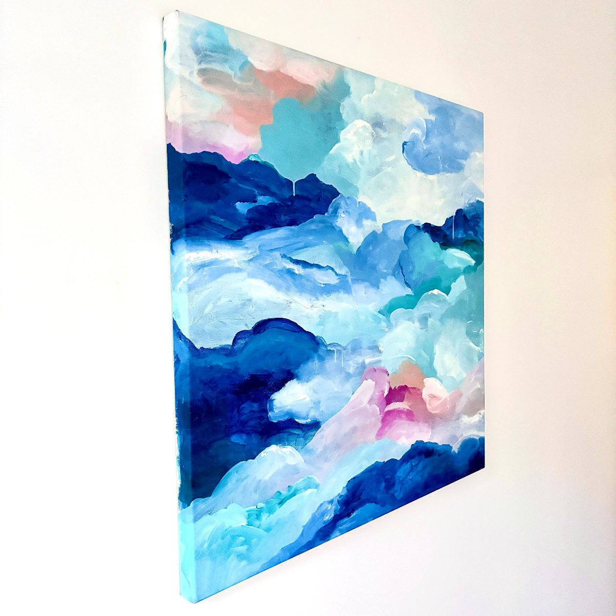 Original artwork of abstract clouds of blue, green, white and peach on a side angle