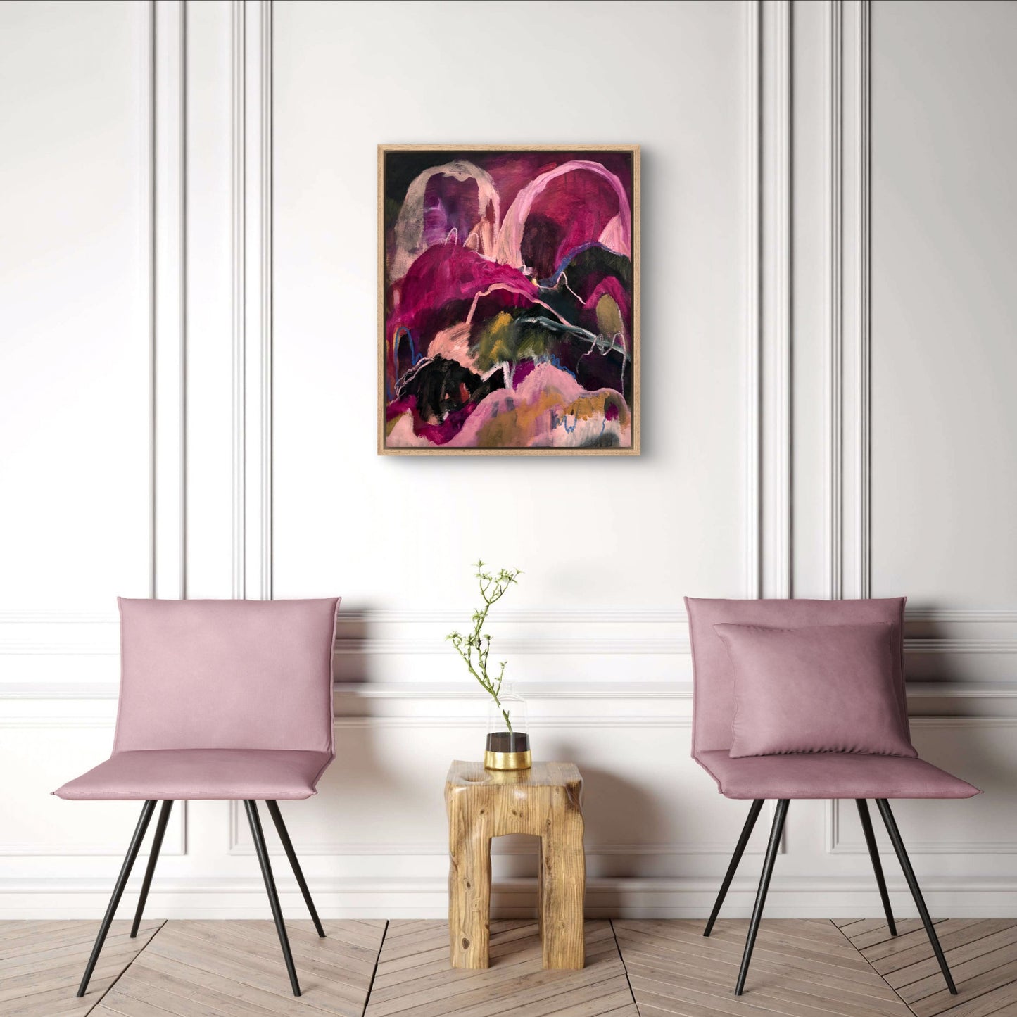 Abstract landscape painting with bright pinks, dark greens and peaches, hanging on a white wall between two dusk pink chairs