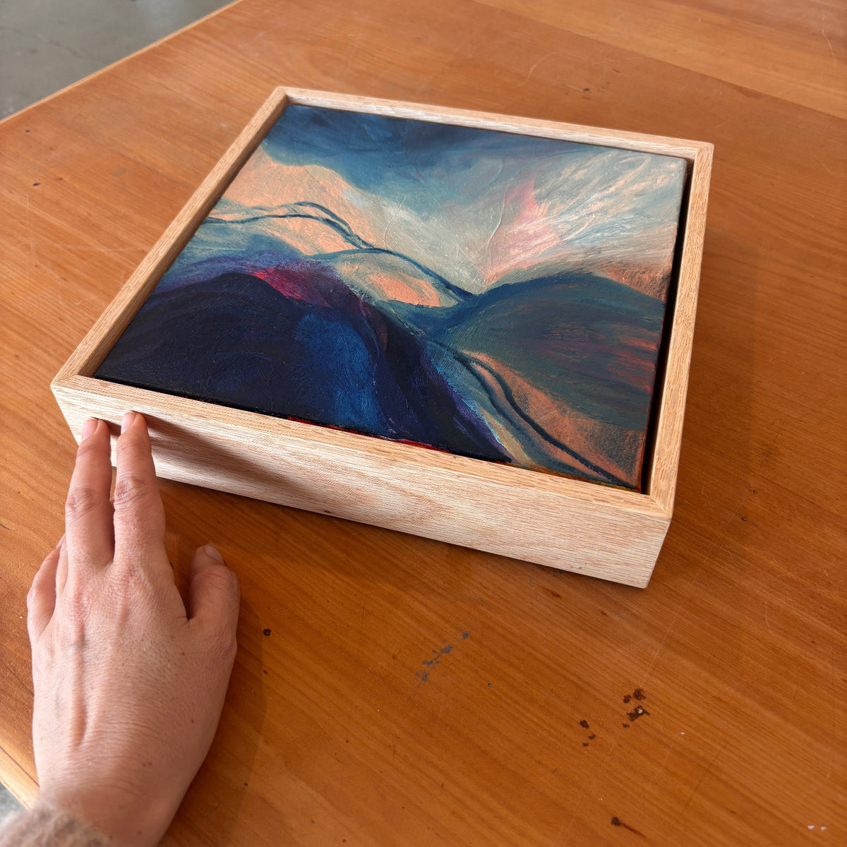 Blue and peach abstract landscape in an oak frame