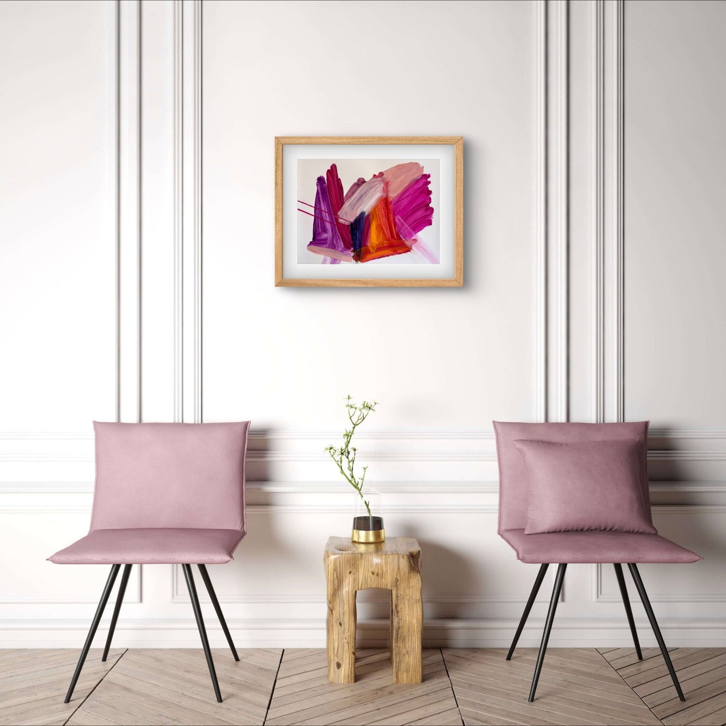Bright expressive abstract artwprk on paper with pink, purple, orange and peach colours in an oak frame hanging above two mauve chairs
