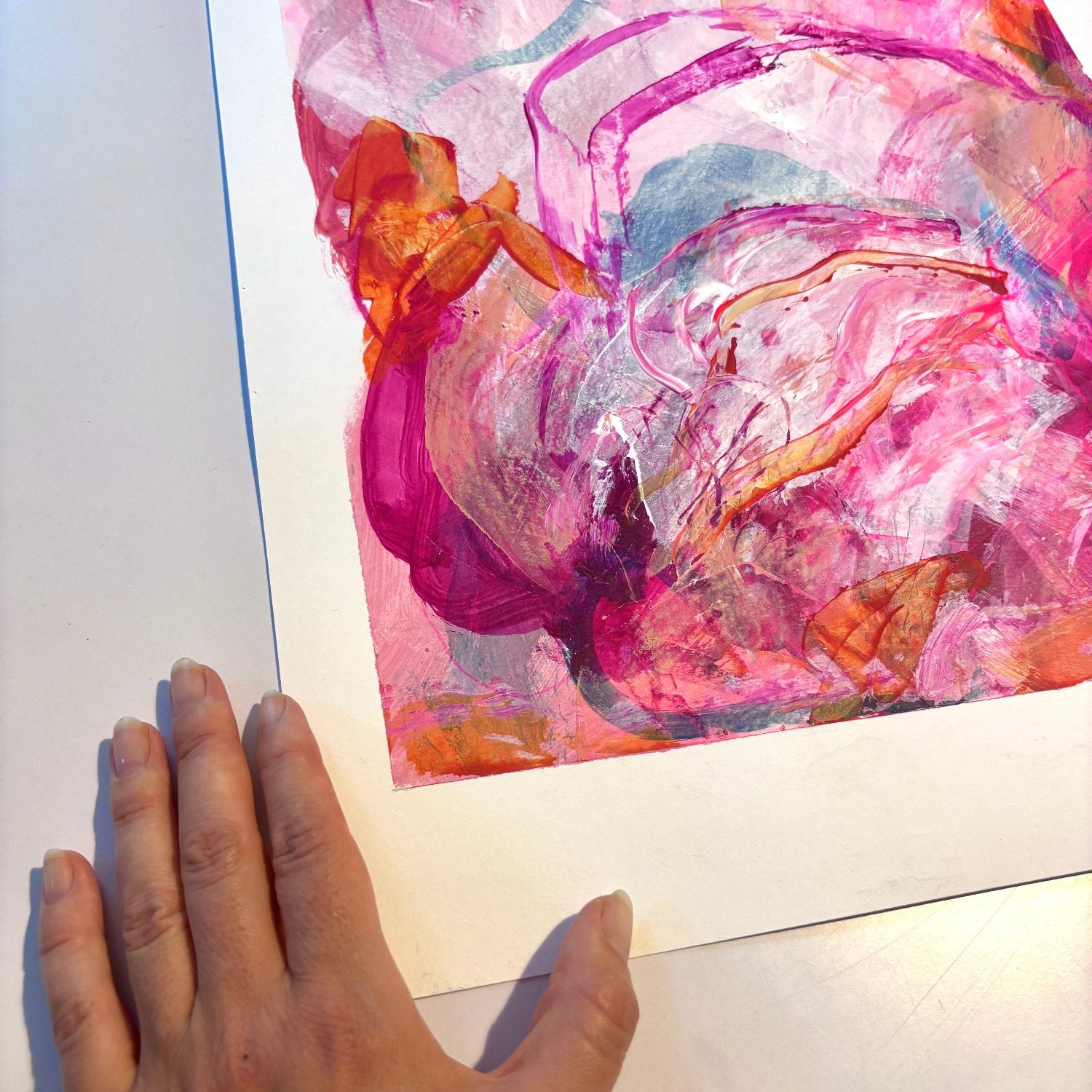 Abstract painting on paper with bright pink, orange and peach colours 