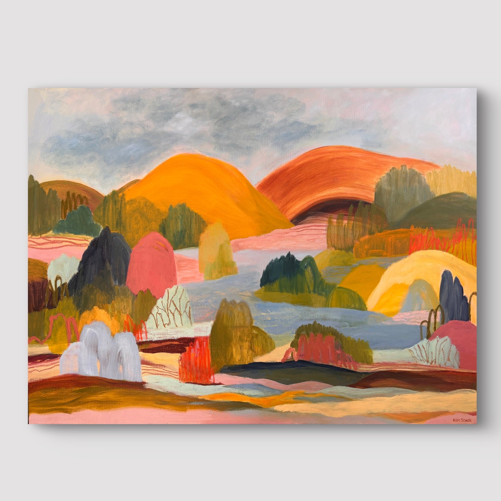 A colorful abstract landscape painting on canvas, featuring stylized hills, trees, and water in warm orange, yellow, green, pink, and blue tones, shown against a light gray background.