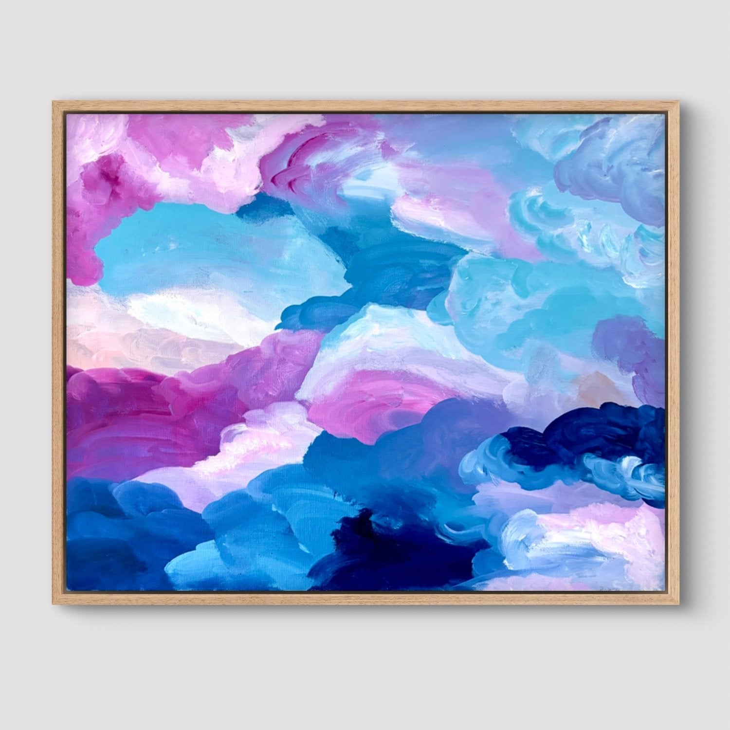 Framed original artwork of clouds in pink, blue and white on a neutral background