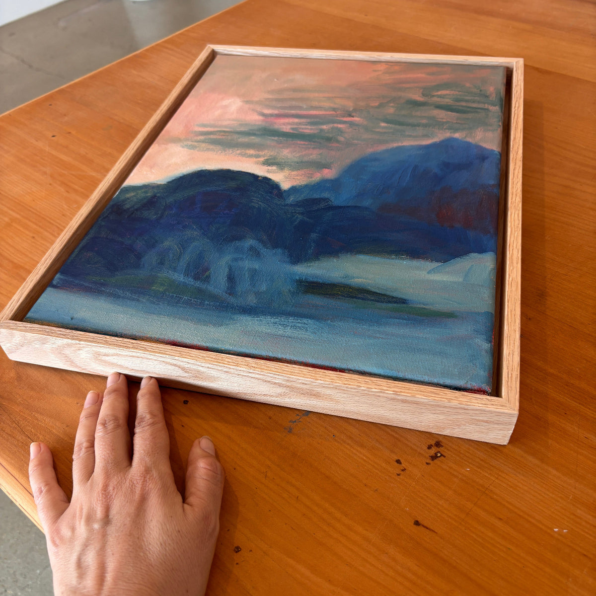side angle of a blue and peach abstract painting